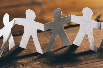 Group of paper people holding hands. Teamwork concept- Stock Photo or Stock Video of rcfotostock | RC-Photo-Stock