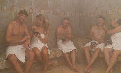 Group of people in a steam bath, rubbing themselves with salt, chatting and smiling in a spa wellness hotel- Stock Photo or Stock Video of rcfotostock | RC Photo Stock