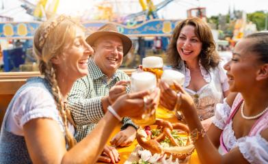 Group of people in proper Tracht drinking Bavarian beer in mugs at oktoberfest or duld in germany - Stock Photo or Stock Video of rcfotostock | RC Photo Stock