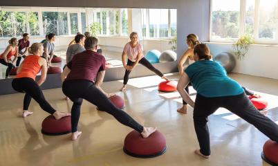 Group of people stretching on Bosu Balls in a fitness class with large windows : Stock Photo or Stock Video Download rcfotostock photos, images and assets rcfotostock | RC Photo Stock.: