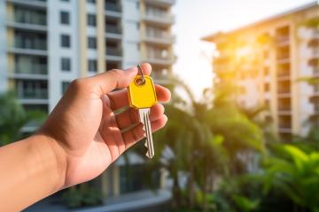 Hand holding a keychain with a house symbol in front of buildings
 : Stock Photo or Stock Video Download rcfotostock photos, images and assets rcfotostock | RC Photo Stock.: