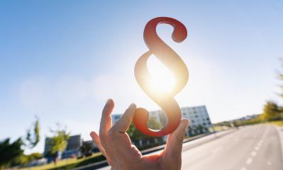 Hand holds paragraph sign in the sun as a symbol for idea of law- Stock Photo or Stock Video of rcfotostock | RC-Photo-Stock