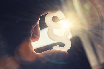 Hand holds paragraph symbol in to the sun : Stock Photo or Stock Video Download rcfotostock photos, images and assets rcfotostock | RC-Photo-Stock.:
