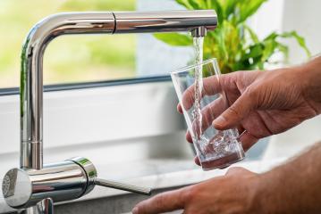 hand pours water into a glass from faucet at the kitchen- Stock Photo or Stock Video of rcfotostock | RC Photo Stock