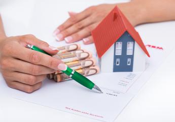 Hands holding a pen over financial documents with euro notes and a miniature house model, symbolizing real estate investment, home financing, or property purchase planning : Stock Photo or Stock Video Download rcfotostock photos, images and assets rcfotostock | RC Photo Stock.: