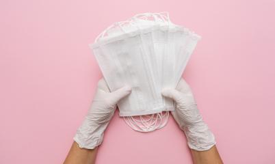 Hands in gloves showing many white medical face mask on pink background. Preventive measures to protect against Covid-19 Corona virus infection.- Stock Photo or Stock Video of rcfotostock | RC Photo Stock