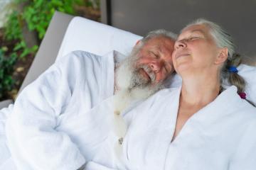 Handsome old man and attractive old woman relaxing  together on deck chair at wellness spa resort. Senior Moments concept image : Stock Photo or Stock Video Download rcfotostock photos, images and assets rcfotostock | RC Photo Stock.: