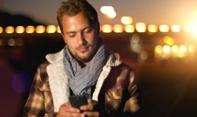 Handsome young man sms texting using app on smart phone at autum /summer sunset in city- Stock Photo or Stock Video of rcfotostock | RC Photo Stock