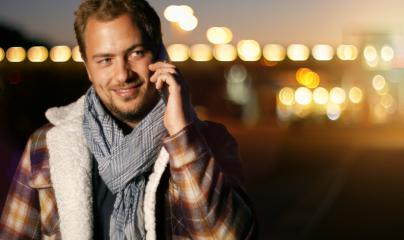Handsome young man speaking on smart phone at autumn sunset in city- Stock Photo or Stock Video of rcfotostock | RC Photo Stock