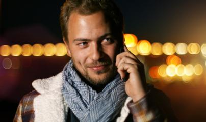 Handsome young man speaking on smart phone at autumn sunset in city- Stock Photo or Stock Video of rcfotostock | RC-Photo-Stock