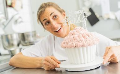 happy confectioner smiling and holding big Birthday cake muffin with candies at pastry bakery : Stock Photo or Stock Video Download rcfotostock photos, images and assets rcfotostock | RC Photo Stock.: