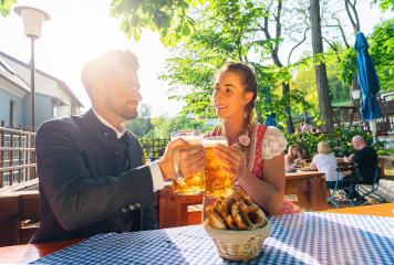 Happy Couple sitting in Beer garden or oktoberfest and enjoying a glass of beer and the sun : Stock Photo or Stock Video Download rcfotostock photos, images and assets rcfotostock | RC Photo Stock.: