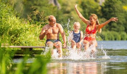 Happy family bathing and splashing water with their foot at jetty on a river in summer : Stock Photo or Stock Video Download rcfotostock photos, images and assets rcfotostock | RC Photo Stock.: