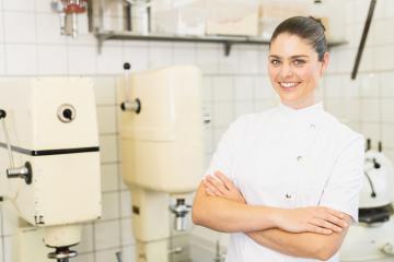Happy female confectioner smiling proudly at her pastry bakery. Cheerful female baker working at pastry bakery kitchen. : Stock Photo or Stock Video Download rcfotostock photos, images and assets rcfotostock | RC Photo Stock.: