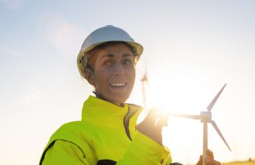 happy female engineer holding wind turbine model looking and checking wind turbines. New Energy concept image- Stock Photo or Stock Video of rcfotostock | RC Photo Stock