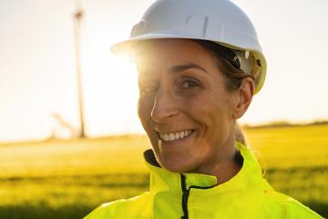 happy female engineer with safety helmet smiling to camera. New Energy concept image : Stock Photo or Stock Video Download rcfotostock photos, images and assets rcfotostock | RC Photo Stock.: