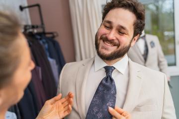 Happy man in a suit being fitted for a tie by a tailor : Stock Photo or Stock Video Download rcfotostock photos, images and assets rcfotostock | RC Photo Stock.: