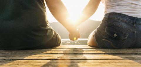 Happy moments together. Happy young couple holding hands sitting on the pier at a lake on sunset : Stock Photo or Stock Video Download rcfotostock photos, images and assets rcfotostock | RC Photo Stock.:
