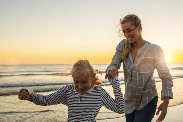 Happy mother and daughter on beach vacation. Mother and little daughter walking and playing together on beach at summer sunset. Happy family travel and vacations concept image.  : Stock Photo or Stock Video Download rcfotostock photos, images and assets rcfotostock | RC Photo Stock.: