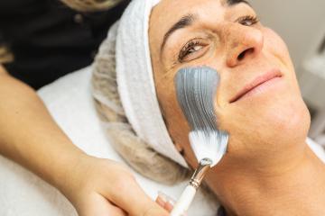 happy woman gets mud mask on face for rejuvenation at the cosmet- Stock Photo or Stock Video of rcfotostock | RC Photo Stock