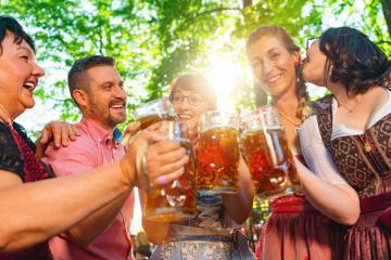 In Beer garden in Bavaria, Germany - friends in Tracht, Dindl and Lederhosen and Dirndl standing in Bavarian beer garden or oktoberfest : Stock Photo or Stock Video Download rcfotostock photos, images and assets rcfotostock | RC Photo Stock.: