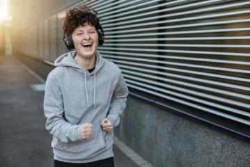 Jogger laughs a lot and is happy. Sporty person is motivated.- Stock Photo or Stock Video of rcfotostock | RC-Photo-Stock