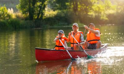 Joyful family of three canoeing on a calm river, with splashing water and lush greenery illuminated by sunlight at summer in bavaria, germany. Family on kayak ride. Wild nature and water fun on summer : Stock Photo or Stock Video Download rcfotostock photos, images and assets rcfotostock | RC Photo Stock.: