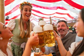 joyful group celebrating at Oktoberfest, raising large beer mugs in a festive beer tent, sharing smiles and toasts, surrounded by vibrant decor : Stock Photo or Stock Video Download rcfotostock photos, images and assets rcfotostock | RC Photo Stock.: