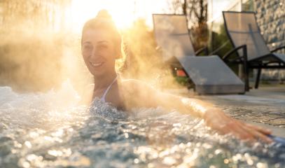 Joyful woman in a hot tub with steam and sunlight- Stock Photo or Stock Video of rcfotostock | RC Photo Stock