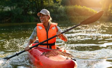 Joyful woman kayaking on a river, paddling with splashes in evening sunlight. Kayak Water Sports concept image : Stock Photo or Stock Video Download rcfotostock photos, images and assets rcfotostock | RC Photo Stock.: