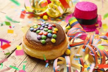 Krapfen, berliner or Carnival donut from Germany with icing sugar on a light wooden surface with confetti and streamers on it - background for a carnival party or parties : Stock Photo or Stock Video Download rcfotostock photos, images and assets rcfotostock | RC Photo Stock.: