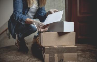 letter carrier drops letters and packages in the hallway without contact in times of quarantine with gloves and ffp2 face mask : Stock Photo or Stock Video Download rcfotostock photos, images and assets rcfotostock | RC Photo Stock.: