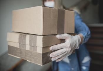 letter carrier drops letters and packages in the hallway without contact in times of quarantine with gloves and ffp2 face mask : Stock Photo or Stock Video Download rcfotostock photos, images and assets rcfotostock | RC Photo Stock.: