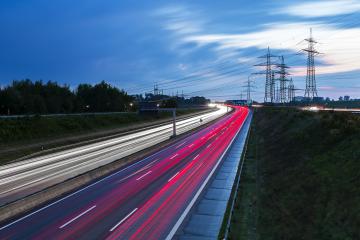 Light trails on a highway freeway at sunset with power Pylons in the background- Stock Photo or Stock Video of rcfotostock | RC Photo Stock