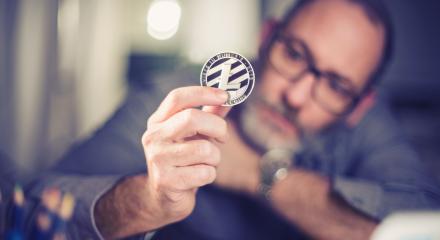 Litecoin cryptocurrency in hand of a casual businessman  : Stock Photo or Stock Video Download rcfotostock photos, images and assets rcfotostock | RC-Photo-Stock.: