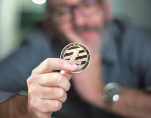 Litecoin cryptocurrency in hand of a casual businessman - Stock Photo or Stock Video of rcfotostock | RC Photo Stock
