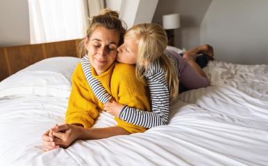 Little girl kissing her mother lying on bed and enjoy the time at home. Mother's Day or mother's love concept image : Stock Photo or Stock Video Download rcfotostock photos, images and assets rcfotostock | RC Photo Stock.:
