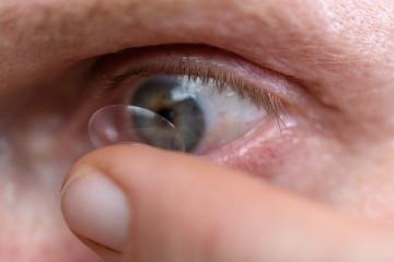 Macro shot of an eye with a contact lens being applied by a fing- Stock Photo or Stock Video of rcfotostock | RC Photo Stock