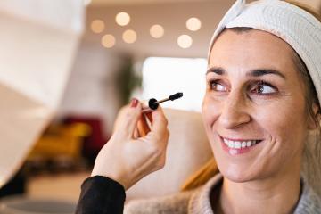 make up assistant applying make up to eyelashes of a happy model for a photoshoot on location.- Stock Photo or Stock Video of rcfotostock | RC Photo Stock