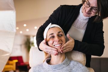 make up assistant applying make up with hand massage of a happy model for a photoshoot or movie on location. : Stock Photo or Stock Video Download rcfotostock photos, images and assets rcfotostock | RC Photo Stock.: