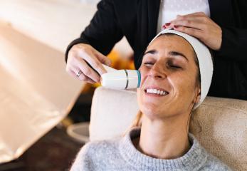 make up assistant cleaning the face of a model with a professional care device for a photoshoot or movie on location. : Stock Photo or Stock Video Download rcfotostock photos, images and assets rcfotostock | RC Photo Stock.: