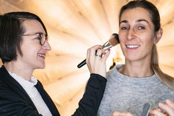 makeup artist working on models face at a Photo shooting or movie set location- Stock Photo or Stock Video of rcfotostock | RC Photo Stock