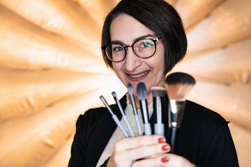 Makeup assistant holding a set of makeup brushes at a photostudio- Stock Photo or Stock Video of rcfotostock | RC Photo Stock