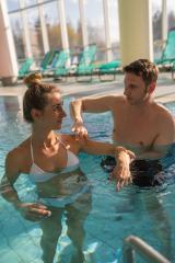 male trainer conducting a rehabilitation session with a female client in an indoor pool- Stock Photo or Stock Video of rcfotostock | RC Photo Stock