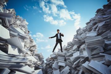 Man balancing on paper piles under a cloudy sky
 : Stock Photo or Stock Video Download rcfotostock photos, images and assets rcfotostock | RC Photo Stock.: