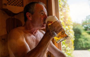 Man drinking german beer in bavarian sauna, sunlight through window. Spa Wellness  hotel concept image- Stock Photo or Stock Video of rcfotostock | RC Photo Stock