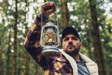 Man hand holding gas lantern in the deep forest- Stock Photo or Stock Video of rcfotostock | RC Photo Stock