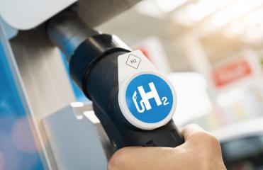 Man hold a fuel dispenser with hydrogen logo on gas station. h2 combustion engine for emission free eco friendly transport concept image- Stock Photo or Stock Video of rcfotostock | RC Photo Stock