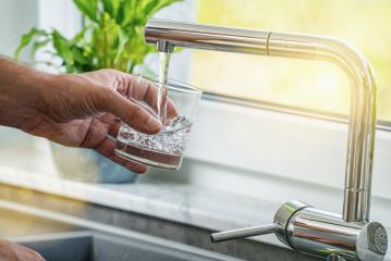 man pouring a glass of fresh water from a kitchen faucet- Stock Photo or Stock Video of rcfotostock | RC Photo Stock