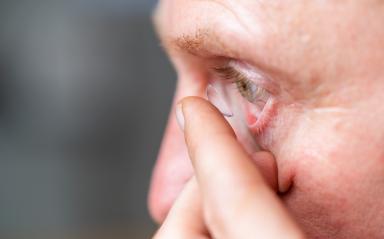 man putting contact lens in his eye on blurred background, close- Stock Photo or Stock Video of rcfotostock | RC Photo Stock